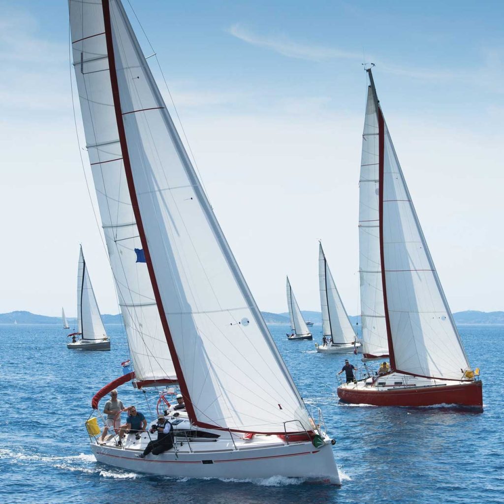 Sailing yachts with full sails on the sea in Halkidiki, northern Greece