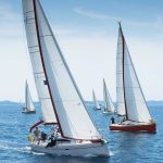 Sailing yachts with full sails on the sea in Halkidiki, northern Greece