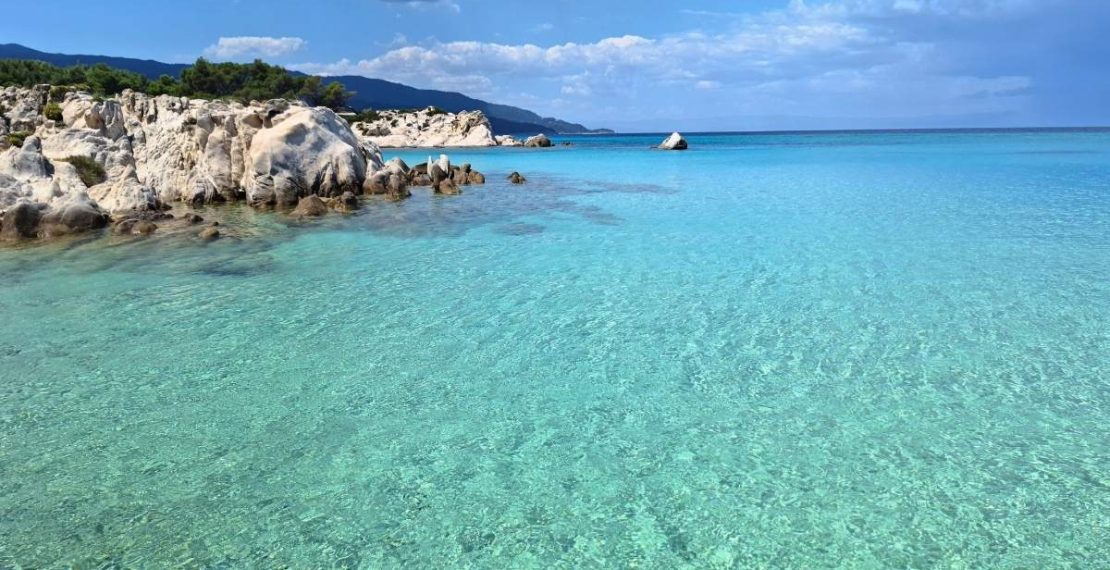 Orange Beach Sithonia with clear turquoise water and scenic white rock formations