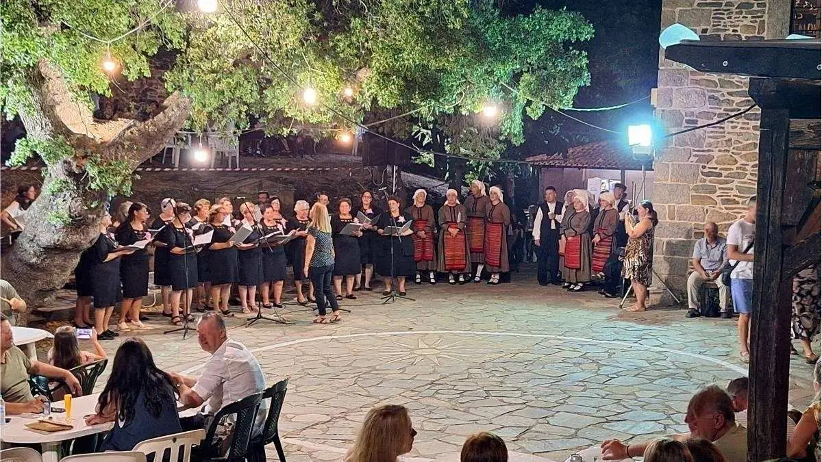Parthenonas Ethno Village choir performing traditional Greek folk dances in front of the local museum, Sithonia, Halkidiki