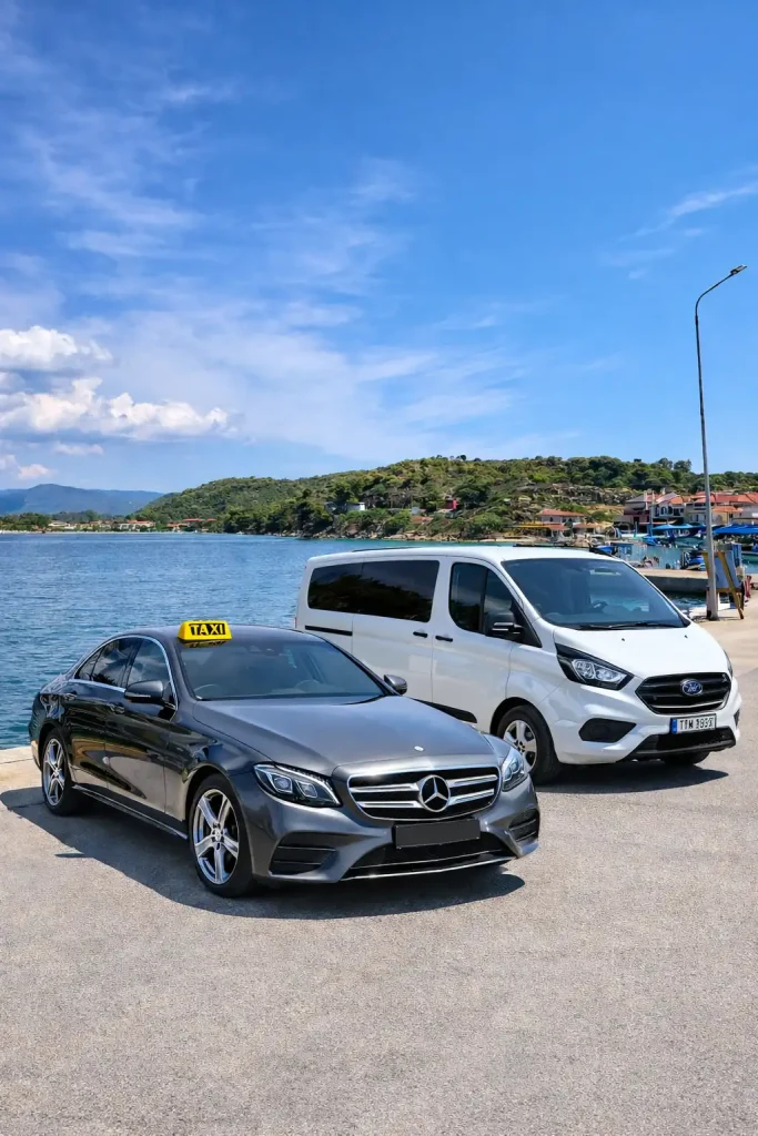 Mercedes taxi and white van at Ormos Panagias dock in Halkidiki, northern Greece