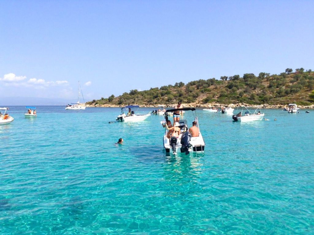 Boat rental exploring the turquoise waters near Diaporos Island and Blue Lagoon in Sithonia