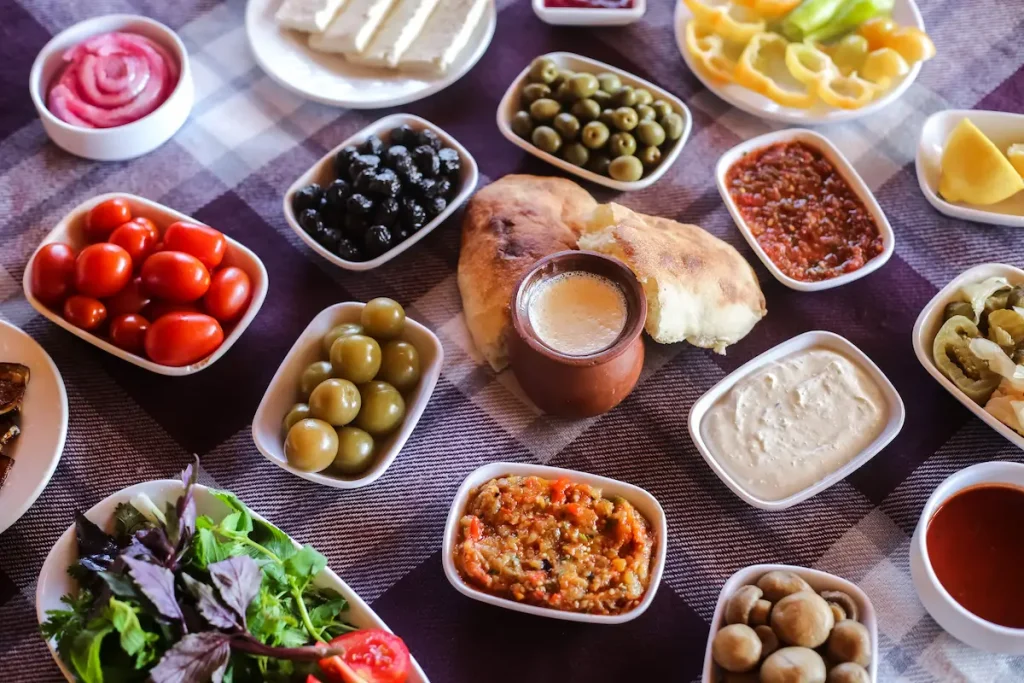 Greek meze with a variety of small plates including seafood, spreads, fresh tomatoes and traditional appetizers